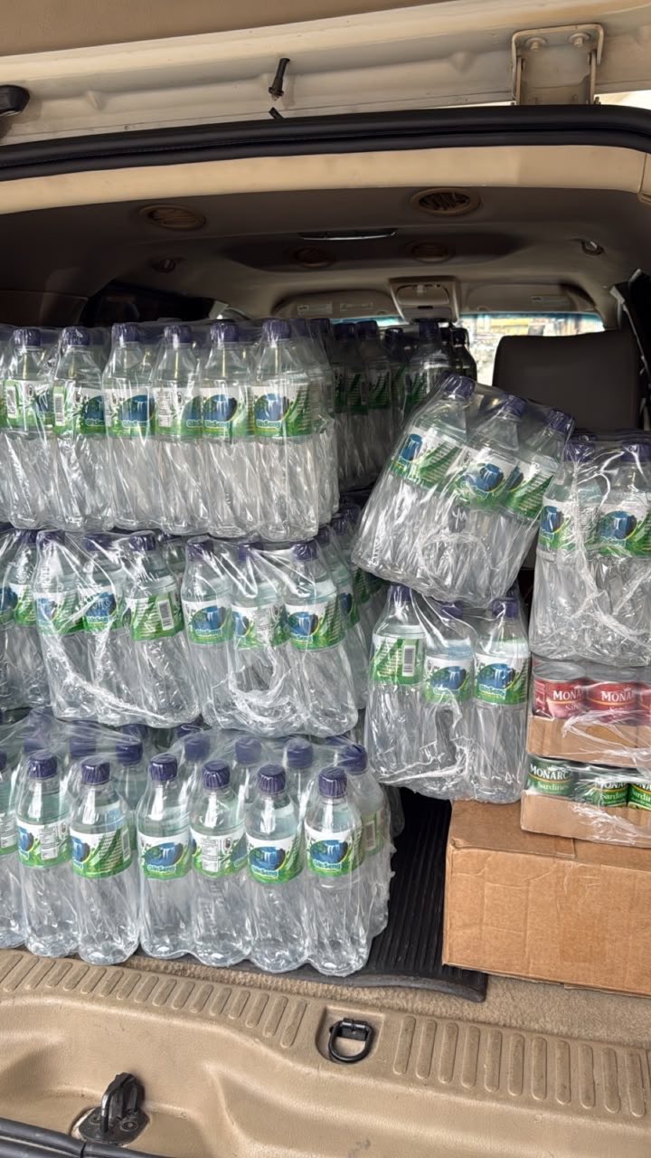 Vehicle loaded with bottled water and canned sardines ready for delivery