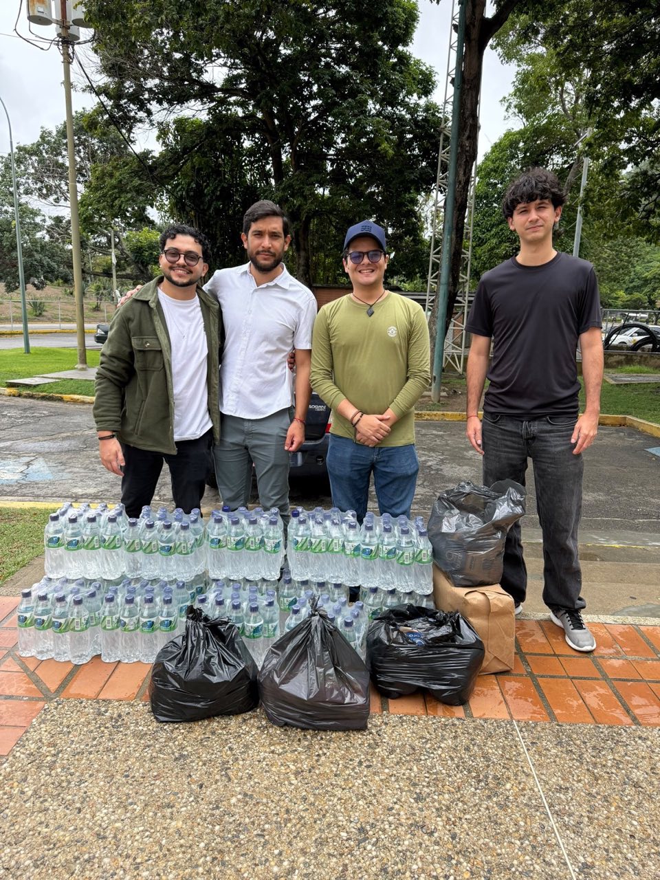 Team members with delivered water and supplies at UCAB